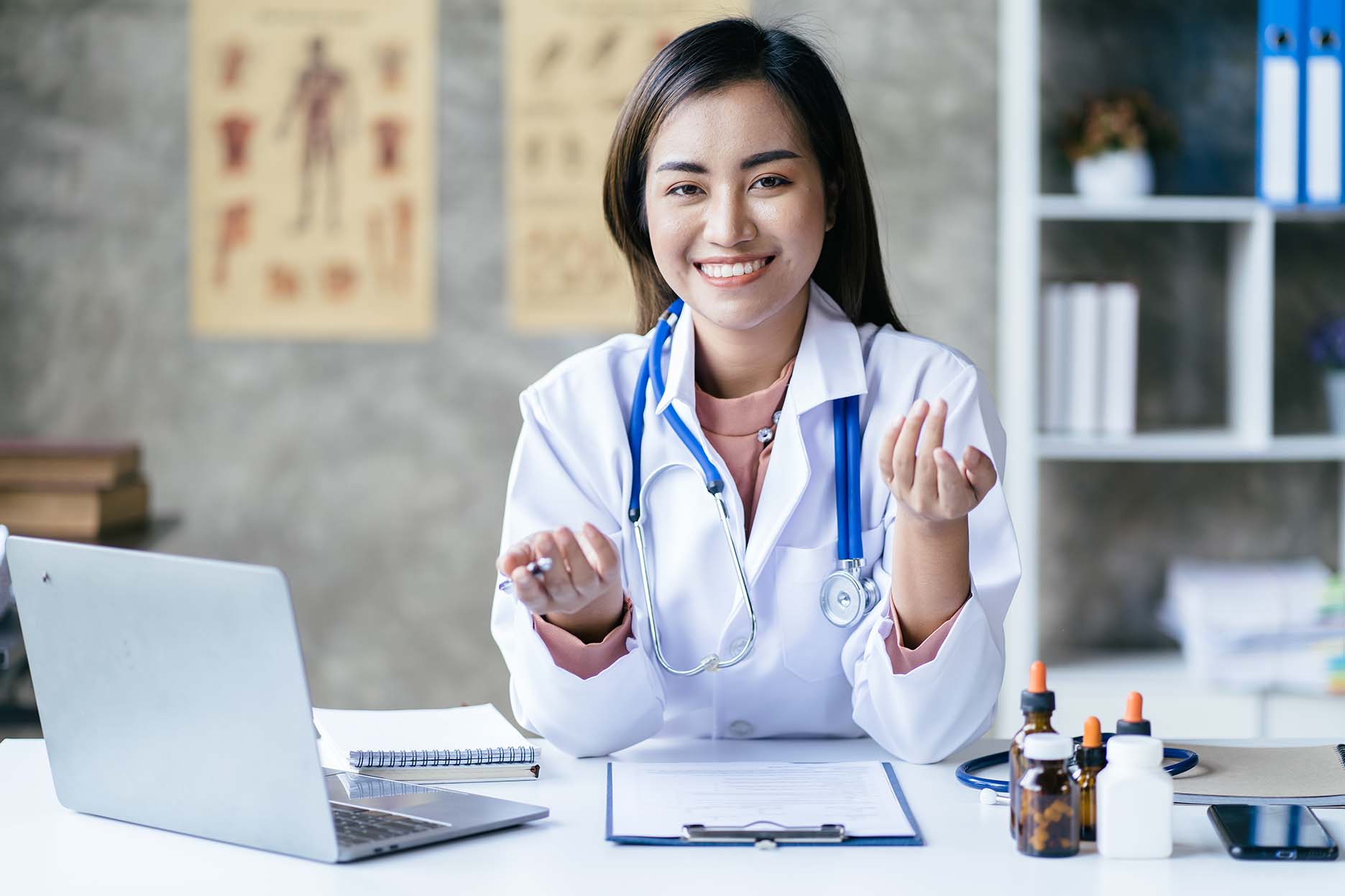 Asian female doctor using laptop computer online video call remo
